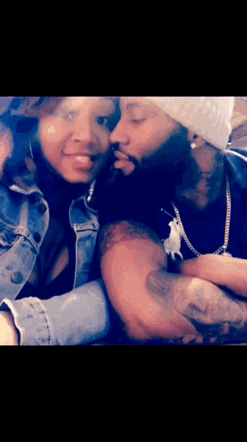 a man is kissing a woman on the cheek
