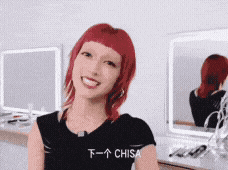 a woman with red hair is wearing a black shirt that says chisa on it