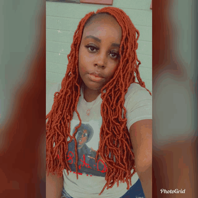 a woman with red dreadlocks is wearing a white shirt that says bad
