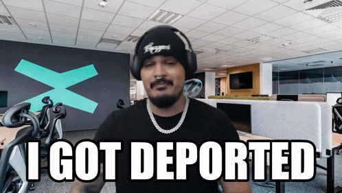 a man wearing a hat and headphones says i got deported