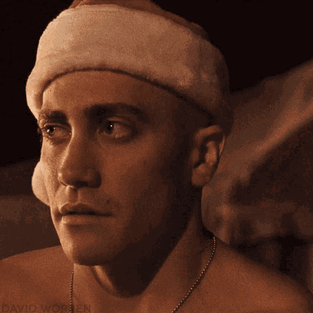 a shirtless man wearing a santa hat with the name david written below him