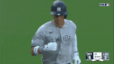 a new york yankees baseball player named oswaldo cabrera is being helped by a referee