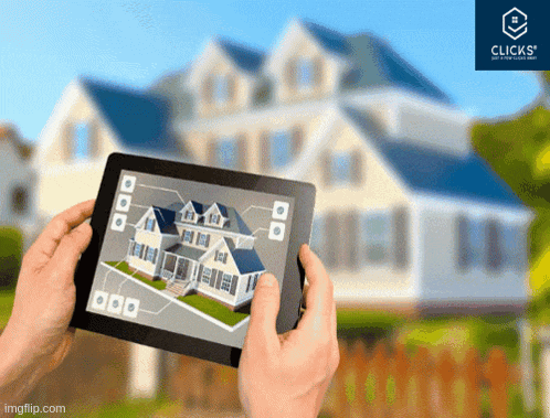 a person holding a tablet in front of a house with a clicks logo in the corner