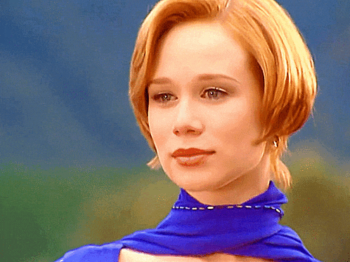a close up of a woman wearing a blue scarf