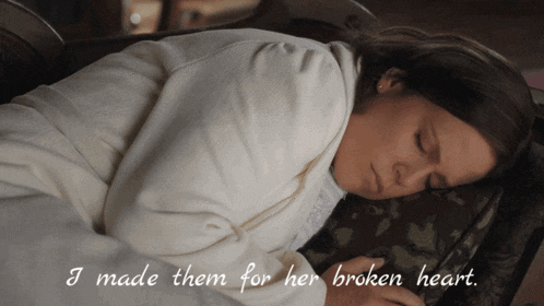 a woman laying down with the words " i made them for her broken heart "