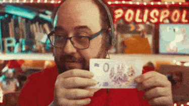 a man wearing headphones is holding a piece of paper with the number 0 on it in front of a sign that says polispol