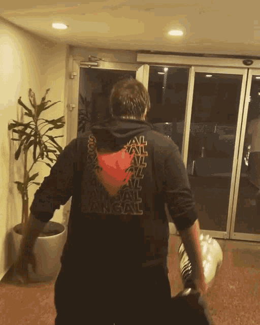 a man wearing a black shirt that says bangal
