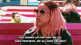 a woman with pink hair and sunglasses says " you signed up for this we all have partners we all have siblings ! "