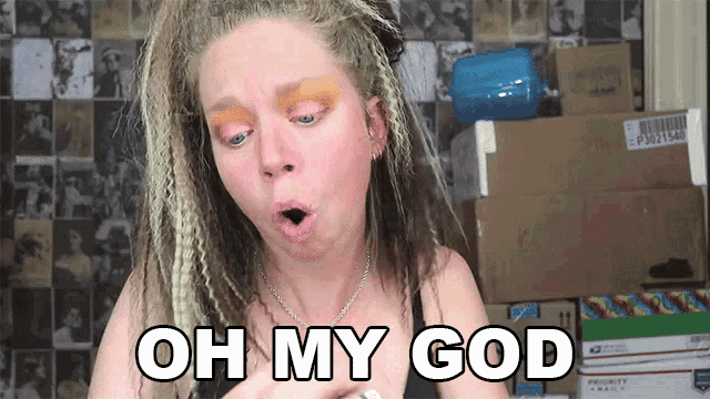 a woman with dreadlocks says oh my god in front of boxes