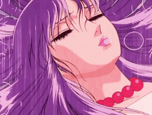 a woman with purple hair and a red necklace is laying down with her eyes closed .