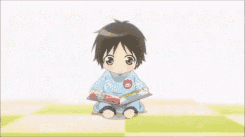 a little boy is sitting on the ground with his mouth open and a heart in his hand .