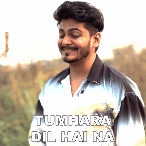 a man with a beard wearing a shirt that says tumhara dil hai na on it