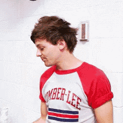 a young man wearing a red and white t-shirt that says amber lee
