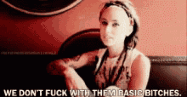 a woman sitting in a chair with the words we don t fuck with them basic bitches