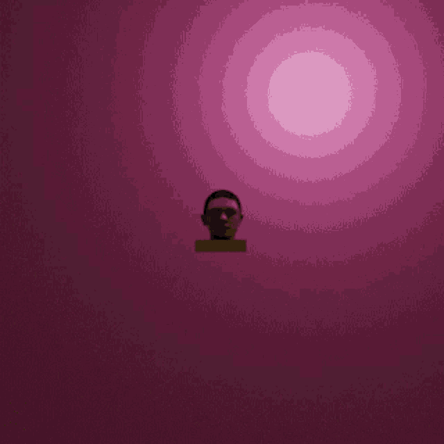 a man 's head is on a pink background
