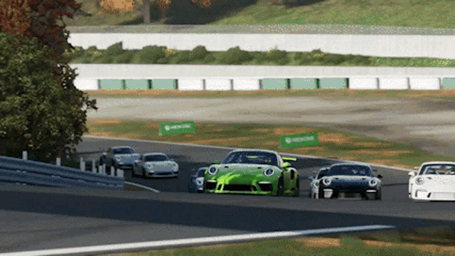 a group of cars are racing on a track with a sign that says xboxone