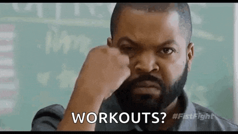 a man with a beard is holding his fist to his face and asking workouts .