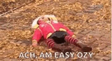 a child is laying on the ground in a pile of leaves with the words `` ach , am easy ozy '' .