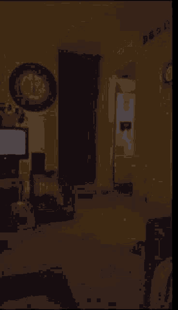 a dark room with a clock on the wall that says ' clock ' on it