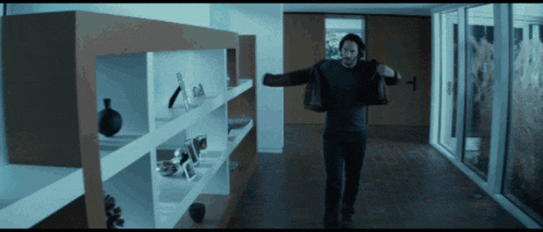 a man in a black shirt is standing in a room