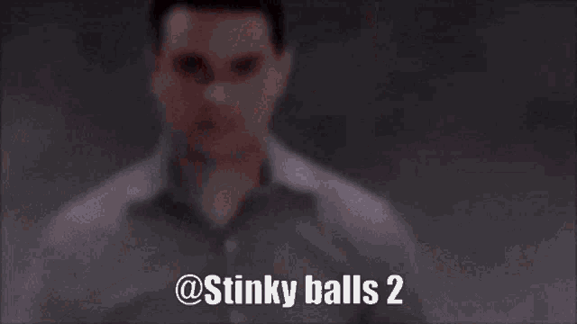 a close up of a man 's face with the words stinky balls 2 written on the bottom