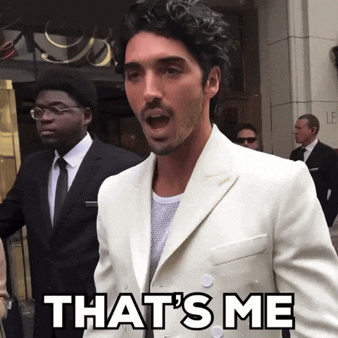 a man in a white suit is saying " that 's me "