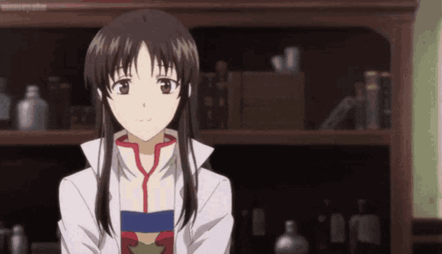 a girl in a lab coat stands in front of a bookshelf with bottles on it