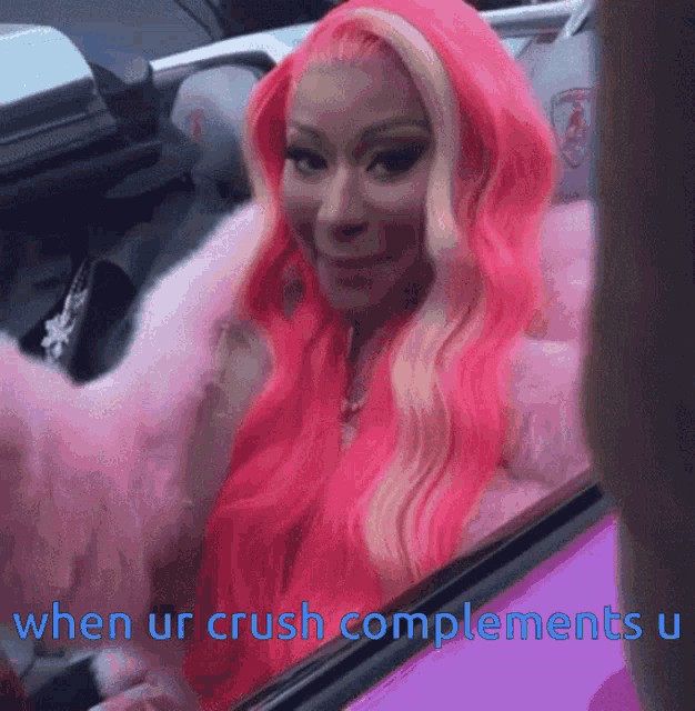 a woman with pink hair is sitting in a car with the words when ur crush complements u