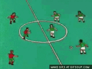 a group of soccer players are playing soccer on a green field .