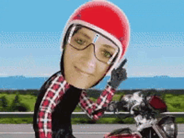a woman wearing a red helmet and glasses is riding a red motorcycle