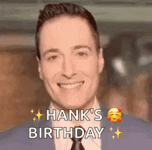 a man in a suit and tie is smiling and wishing hank 's birthday .
