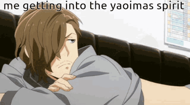 a picture of a man laying on a couch with a caption that says me getting into the yaoimas spirit