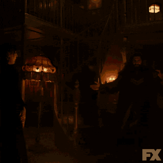 a dark room with a lamp and candles and a fx logo