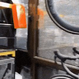 a bicycle wheel is sitting in front of a window in a room