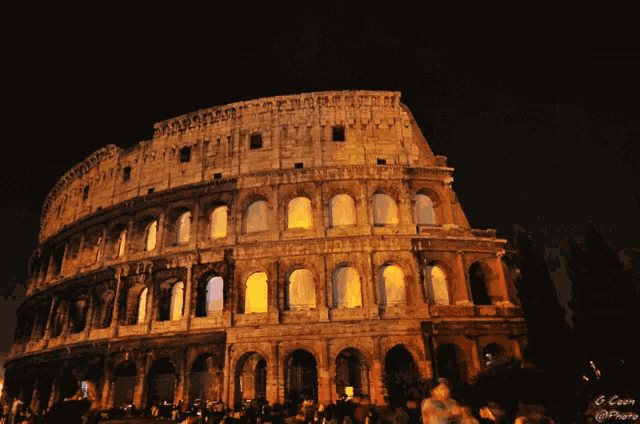 the colosseum is lit up at night with a photo taken by g. coen