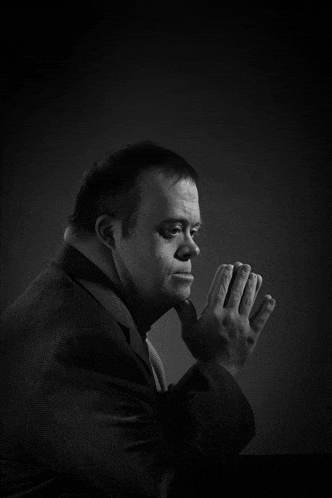 a black and white photo of a man in a suit and tie