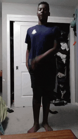 a man in a blue nike shirt stands in a closet