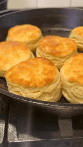 biscuits are being cooked in a pan on a stove top