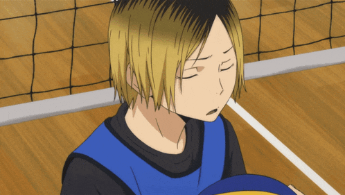 a volleyball player with his eyes closed holds a ball