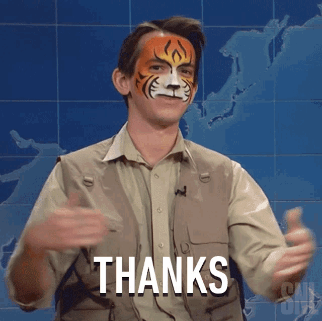 a man with a tiger face painted on his face is saying thanks