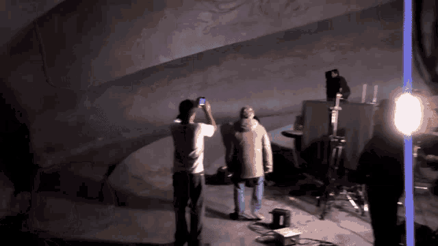 a man is taking a picture of another man with his phone