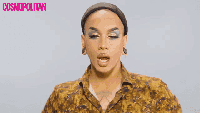 a close up of a person 's face with a cosmopolitan logo in the background