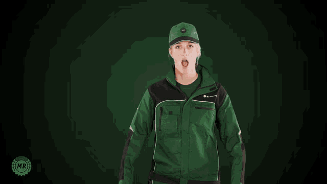 a woman wearing a green and black jacket and hat is making a surprised face