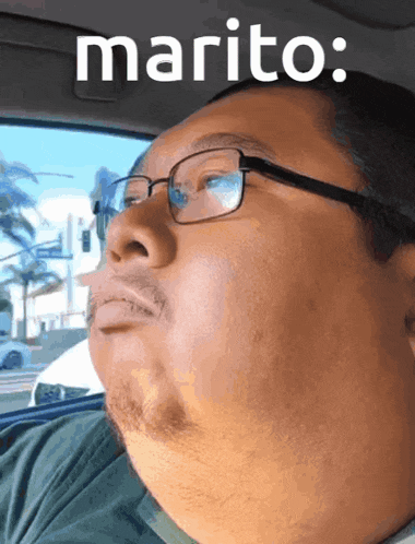 a man wearing glasses is sitting in a car with marito written on the top of his face
