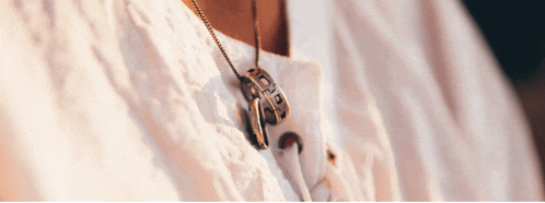 a close up of a person wearing a necklace that says hope