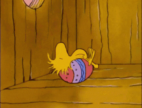 a cartoon of woodstock laying on his back with an easter egg on his head