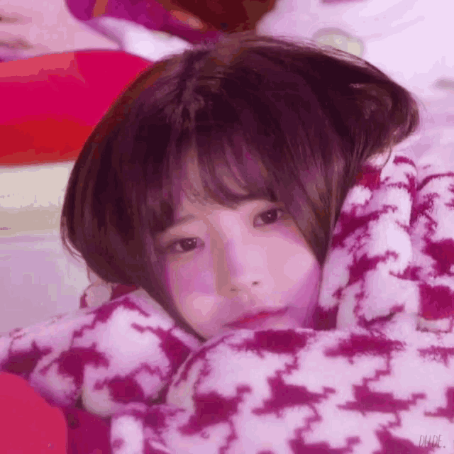 a close up of a girl wrapped in a blanket .