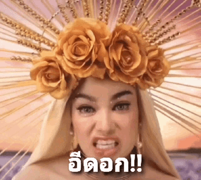 a woman wearing a crown of gold roses is making an angry face