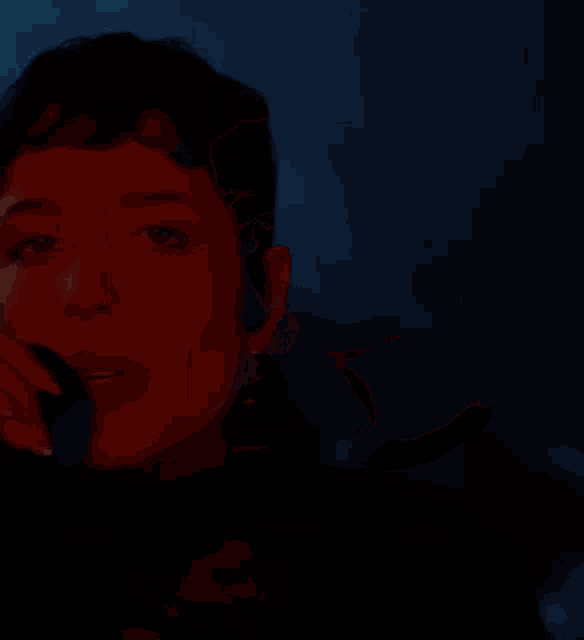 a close up of a woman 's face with a dark background
