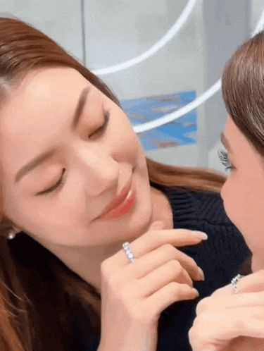 a woman is wearing a ring on her finger